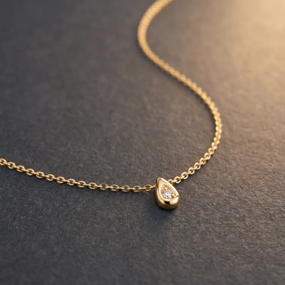 Étoile Pendant — Faceted teardrop with a single diamond, fine cable chain.